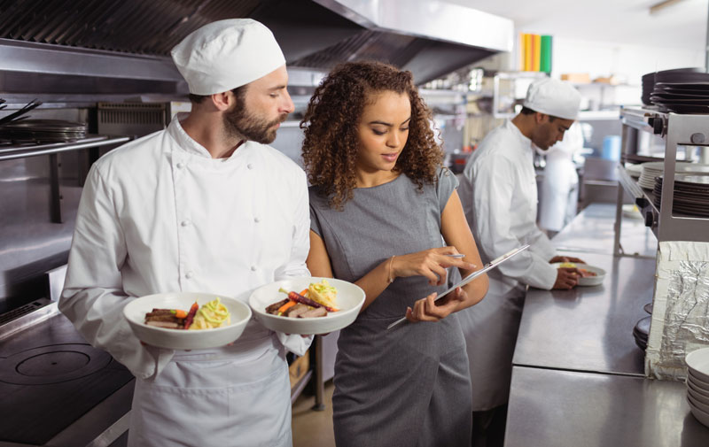 Canada-Ontario Job Grant - a chef receiving training from a woman with a clipboard